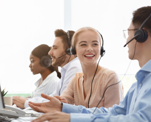 Call centre and customer service. Tech support operators discussing something at workplace
